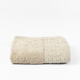 Toalla de algodón beige con textura rizada y ribete decorativo-beige