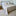 Cubrecama acolchado beige sobre cama con almohadas decorativas-beige