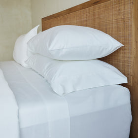 Cama con sábanas blancas de bamboo algodón y almohadas-blanco