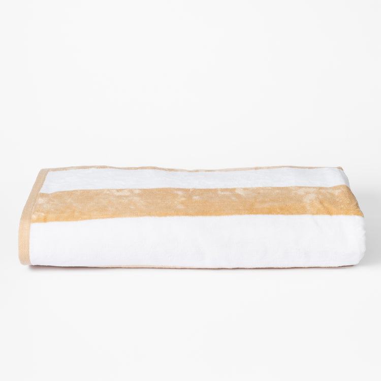 Toalla de playa blanca con franja horizontal beige doblada-azul