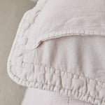 
                    
                      Detalle de funda almohada beige con textura acolchada y fruncido decorativo-
                    
                  