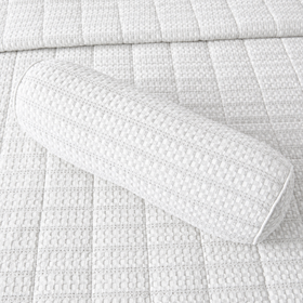 Almohada cilíndrica blanco sobre colcha acolchada de textura cuadriculada-blanco