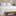 Cubrecama blanco Berna sobre cama con almohadas a juego y banco de madera-blanco