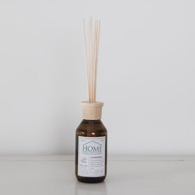 Difusor ambiental Home Collection con varillas de madera y botella ámbar-peonia