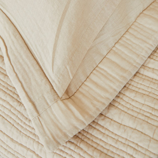 Funda de almohada beige con textura acanalada y pliegues naturales-beige