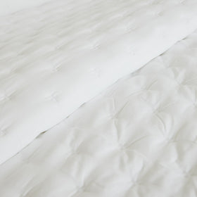 Cubrecama blanco con textura acolchada y patrón geométrico-blanco