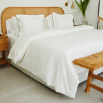 
                    
                      Cama con funda de edredón blanco de algodón y cabecero de ratán-blanco
                    
                  