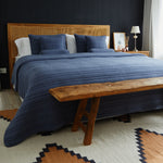 
                    
                      Cubrecama azul con textura acolchada en cama de madera con cabecera-azul
                    
                  
