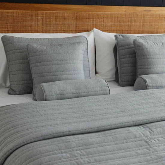 Cubrecama gris Pamplona con almohadas y cojines coordinados en cama-gris