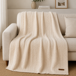 
                    
                      Manta de lana natural con patrón de líneas texturizadas y etiqueta Home Harmony-natural
                    
                  