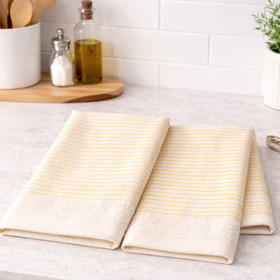 Dos repasadores beige con rayas amarillas sobre mesada de cocina-natural