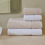 
                    
                      Set de toallas Supreme en tonos beige y blanco apiladas-
                    
                  